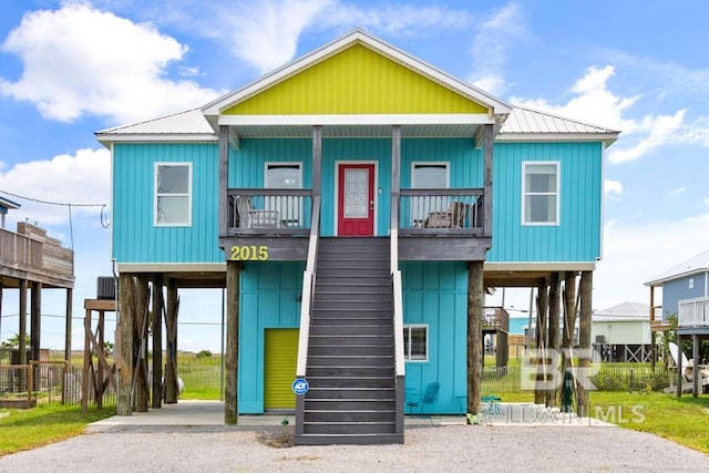 view of front of property with a carport and a balcony