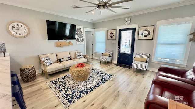 living room with crown molding, ceiling fan, and light hardwood / wood-style floors