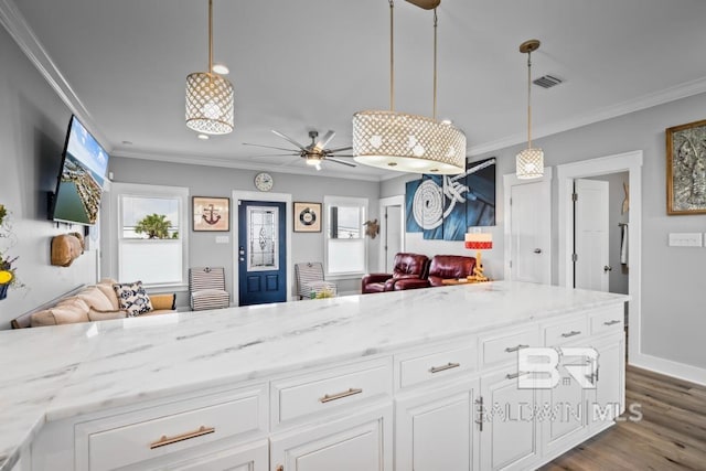 kitchen with white cabinetry, ceiling fan, pendant lighting, light wood-type flooring, and ornamental molding