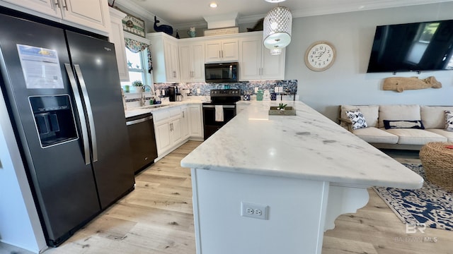 kitchen with sink, tasteful backsplash, ornamental molding, black appliances, and white cabinets