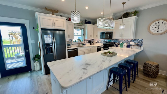 kitchen featuring stainless steel appliances, light hardwood / wood-style floors, tasteful backsplash, and sink