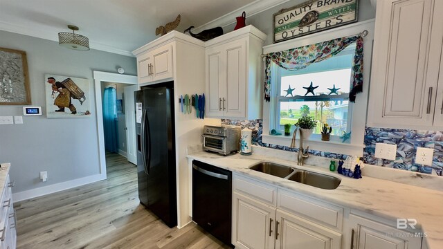 kitchen with light hardwood / wood-style flooring, white cabinets, light stone counters, black appliances, and sink