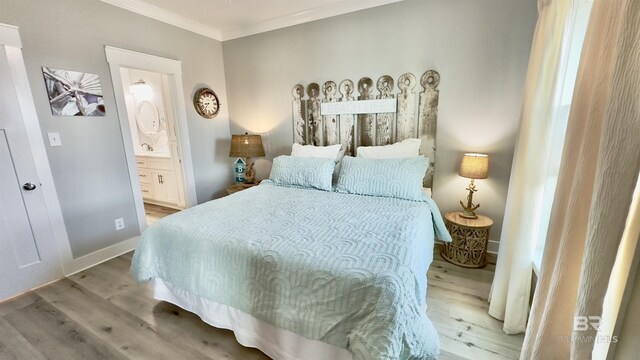 bedroom with ensuite bath, crown molding, and light hardwood / wood-style floors