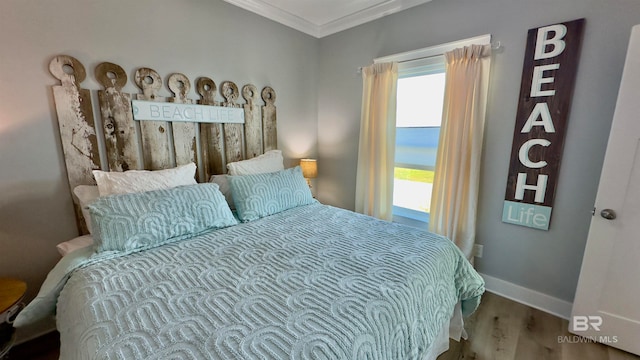 bedroom featuring wood-type flooring and ornamental molding