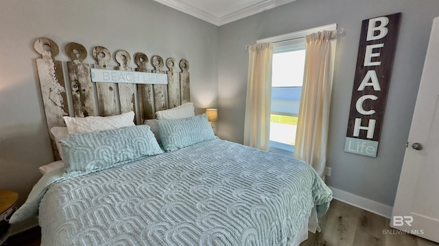 bedroom with hardwood / wood-style flooring and ornamental molding