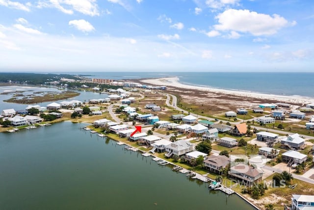 drone / aerial view with a water view and a beach view