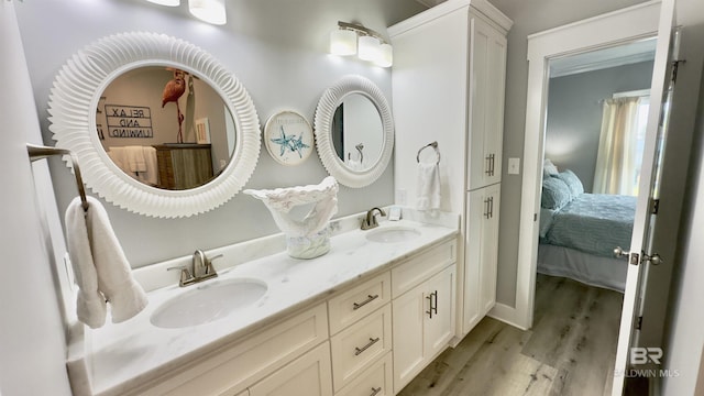 bathroom featuring hardwood / wood-style flooring and double vanity