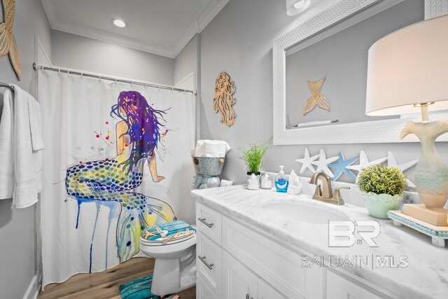 bathroom with ornamental molding, vanity, wood-type flooring, and toilet