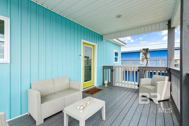 wooden terrace with an outdoor hangout area