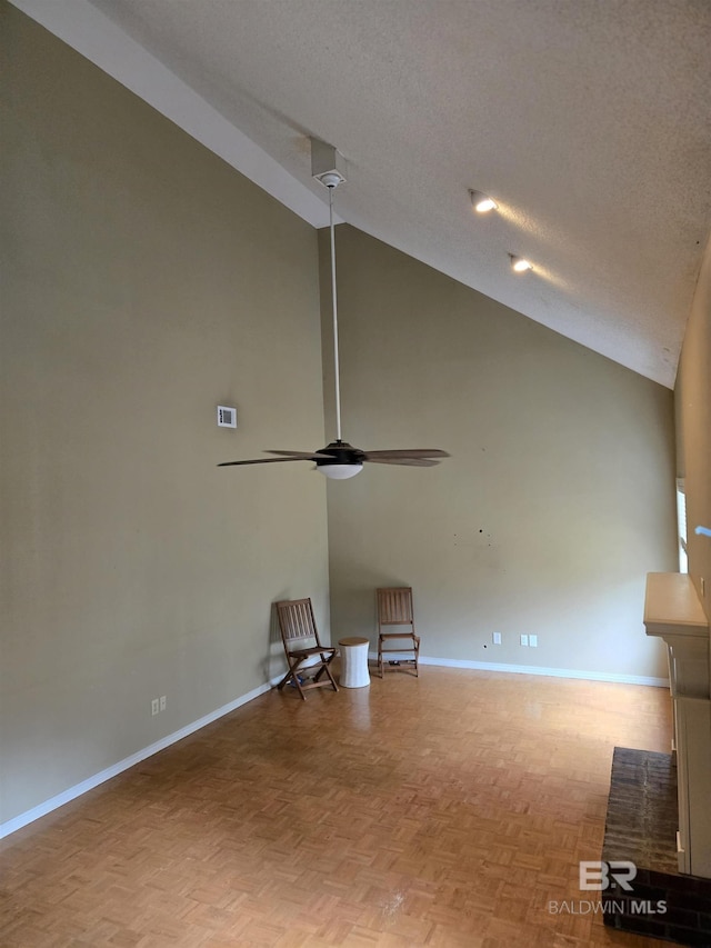 unfurnished living room featuring visible vents, ceiling fan, a textured ceiling, and baseboards