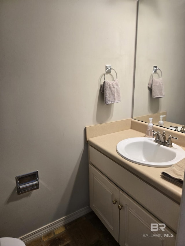 bathroom featuring vanity and baseboards