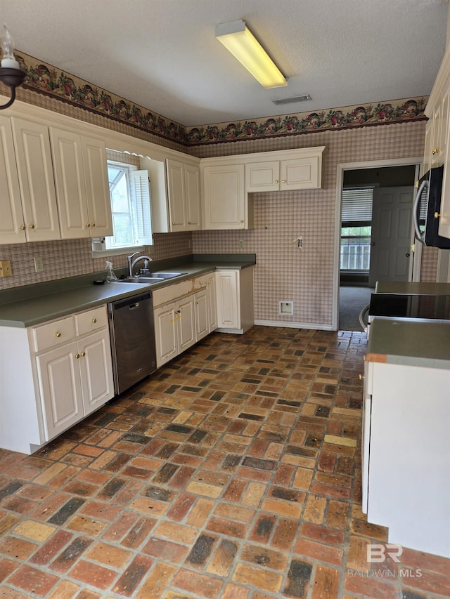 kitchen with wallpapered walls, visible vents, brick floor, stainless steel dishwasher, and a sink