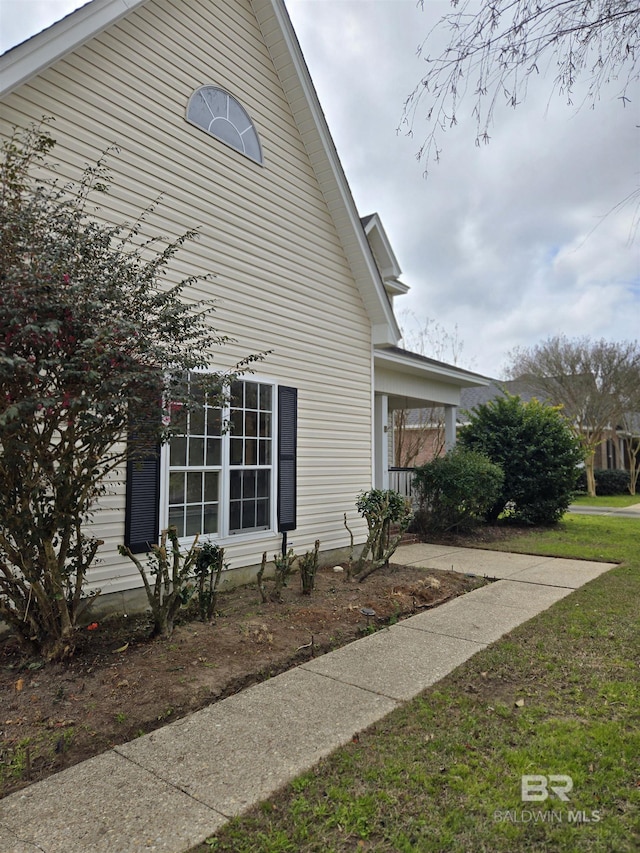 view of side of home featuring a lawn