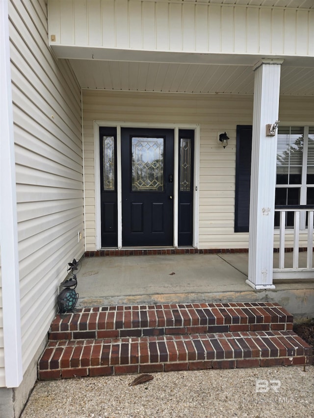 view of exterior entry with covered porch