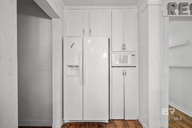 detailed view of white appliances, wood finished floors, and baseboards