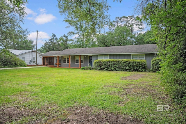 single story home featuring a porch, a front lawn, and board and batten siding