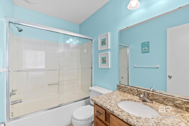 930 W Beach Blvd Unit 108, Gulf Shores, AL 36542 - bathroom with vanity, toilet, combined bath / shower with glass door, and a textured ceiling