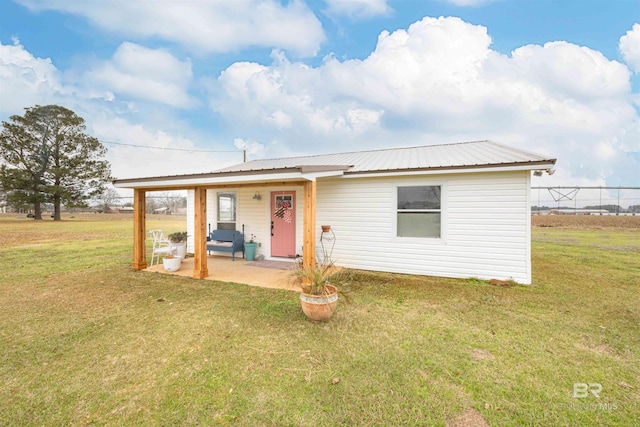 view of front of home with a patio area and a front lawn