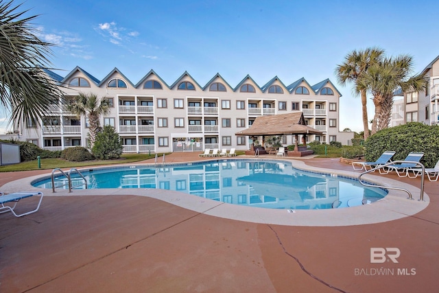 view of swimming pool with a gazebo and a patio area