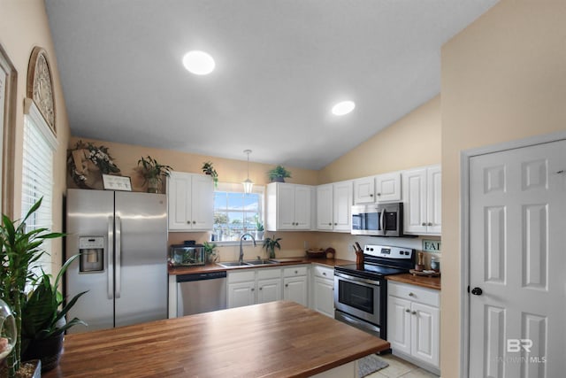 kitchen featuring white cabinetry, sink, hanging light fixtures, and appliances with stainless steel finishes