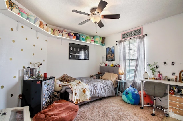 carpeted bedroom with a textured ceiling and ceiling fan