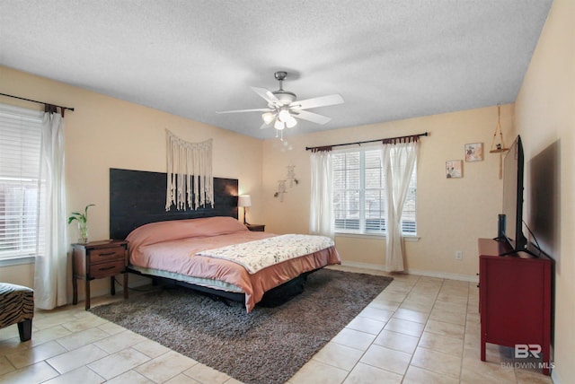 tiled bedroom featuring ceiling fan and a textured ceiling