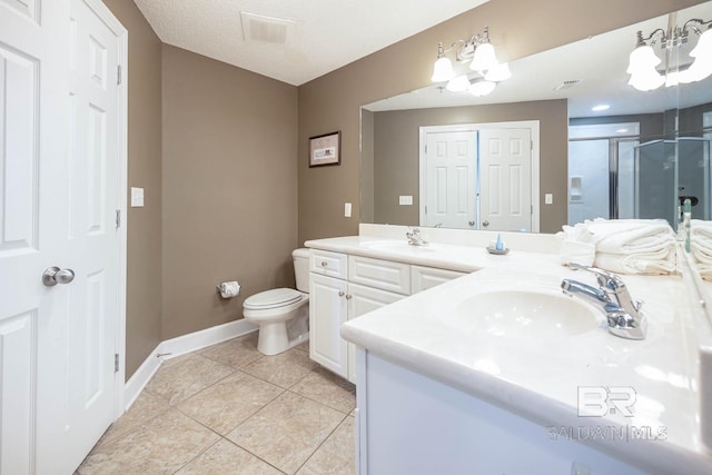 bathroom featuring a notable chandelier, a shower with shower door, a textured ceiling, and vanity