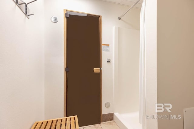 bathroom featuring tile patterned flooring and walk in shower