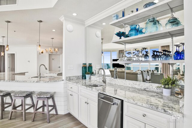 825 W Beach Blvd Unit 10, Gulf Shores, AL 36542 - kitchen with ornamental molding, a sink, and light stone countertops