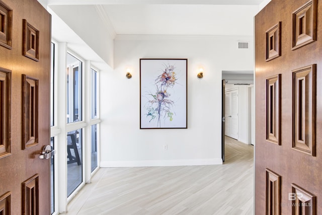825 W Beach Blvd Unit 10, Gulf Shores, AL 36542 - foyer with baseboards, visible vents, ornamental molding, and light wood-style flooring