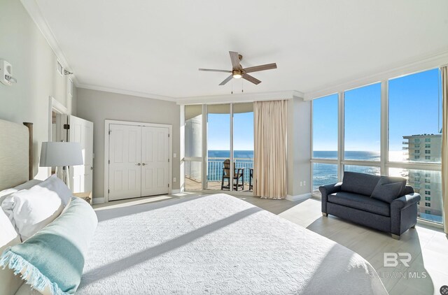 825 W Beach Blvd Unit 10, Gulf Shores, AL 36542 - bedroom featuring a wall of windows, access to outside, a water view, and crown molding