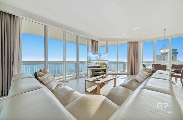 825 W Beach Blvd Unit 10, Gulf Shores, AL 36542 - living room featuring a water view, an inviting chandelier, wood finished floors, and floor to ceiling windows