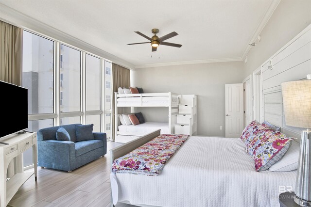 825 W Beach Blvd Unit 10, Gulf Shores, AL 36542 - bedroom featuring ornamental molding, a ceiling fan, and wood finished floors