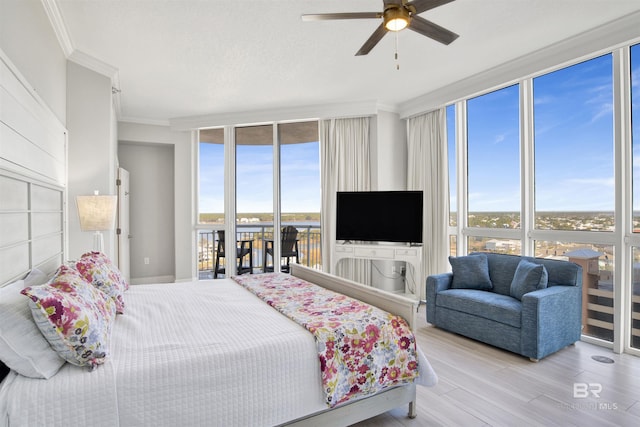 825 W Beach Blvd Unit 10, Gulf Shores, AL 36542 - bedroom with access to outside, a wall of windows, wood finished floors, and crown molding