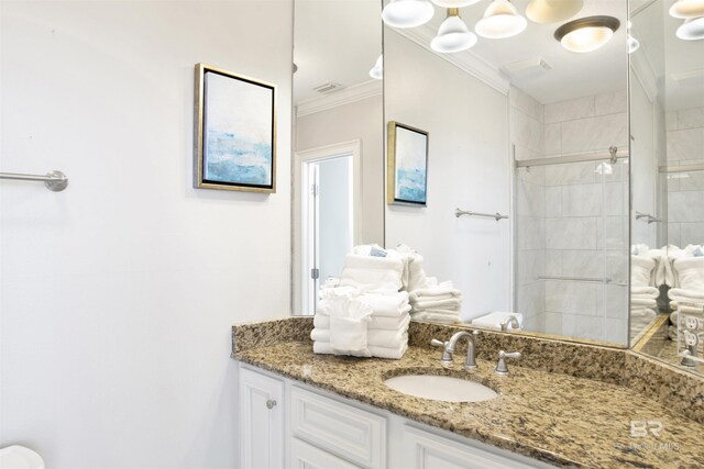 825 W Beach Blvd Unit 10, Gulf Shores, AL 36542 - bathroom with visible vents, ornamental molding, tiled shower, and vanity