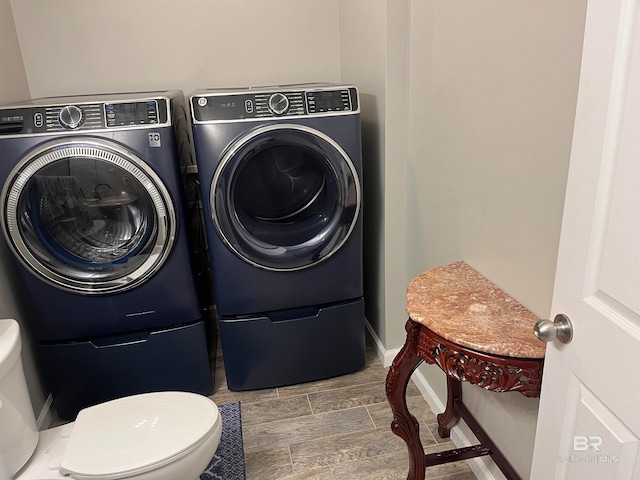 laundry area featuring hardwood / wood-style flooring and washer and clothes dryer