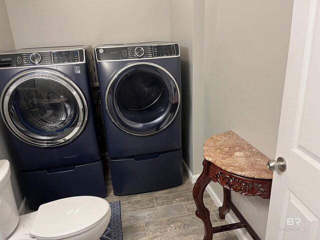 1517 Regency Rd Unit 161, Gulf Shores, AL 36542 - laundry area with washer and clothes dryer, wood tiled floors, and baseboards
