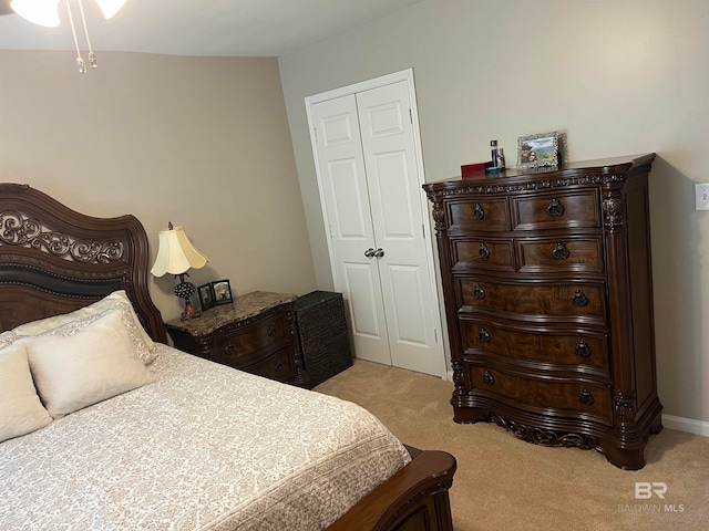 bedroom with a closet and light colored carpet