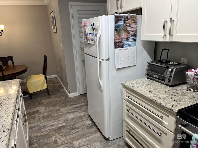 1517 Regency Rd Unit 161, Gulf Shores, AL 36542 - kitchen featuring dark wood-type flooring, white cabinets, light stone countertops, freestanding refrigerator, and ornamental molding