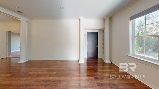 unfurnished room featuring a wealth of natural light, dark wood-type flooring, and ornamental molding