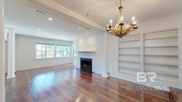 unfurnished living room featuring an inviting chandelier, dark hardwood / wood-style floors, ornate columns, ornamental molding, and a fireplace