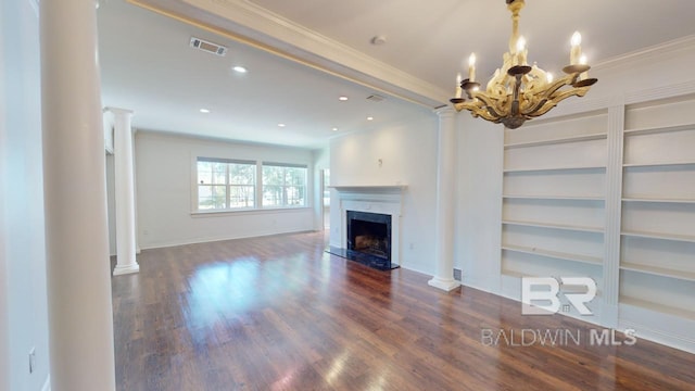 unfurnished living room featuring decorative columns, crown molding, dark hardwood / wood-style flooring, and a chandelier