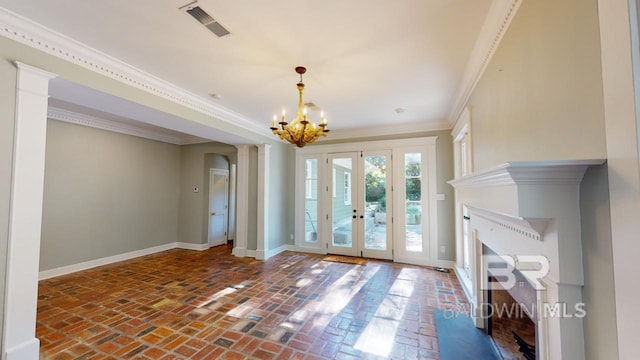 doorway with french doors, a notable chandelier, and ornamental molding