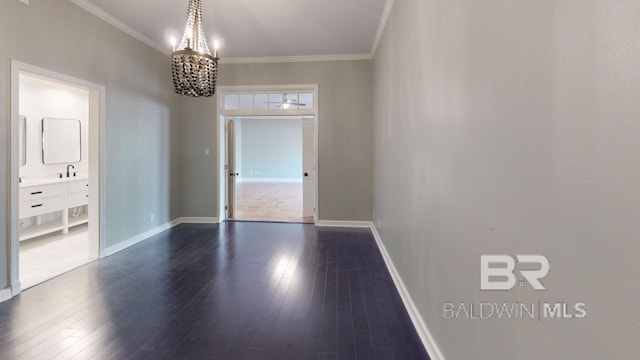 interior space with dark hardwood / wood-style flooring, crown molding, and a notable chandelier