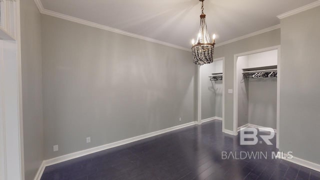 unfurnished bedroom featuring dark hardwood / wood-style floors, a closet, crown molding, and an inviting chandelier