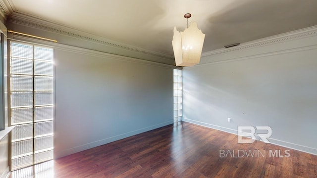 empty room with dark hardwood / wood-style flooring, crown molding, and a notable chandelier