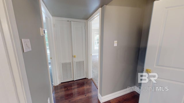 corridor featuring dark hardwood / wood-style floors