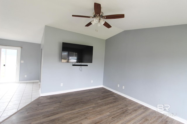 unfurnished living room with ceiling fan, lofted ceiling, and wood-type flooring