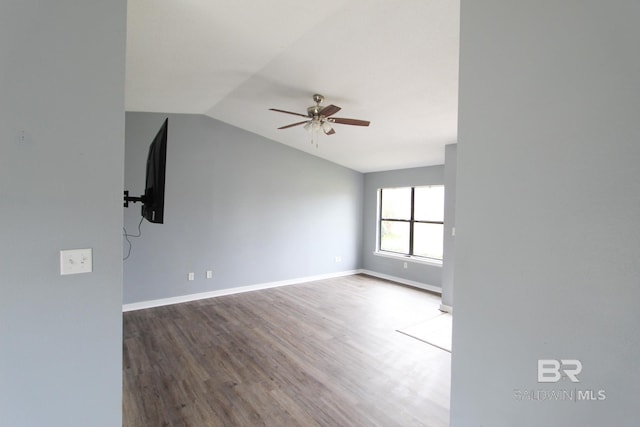 empty room featuring hardwood / wood-style flooring, ceiling fan, and vaulted ceiling