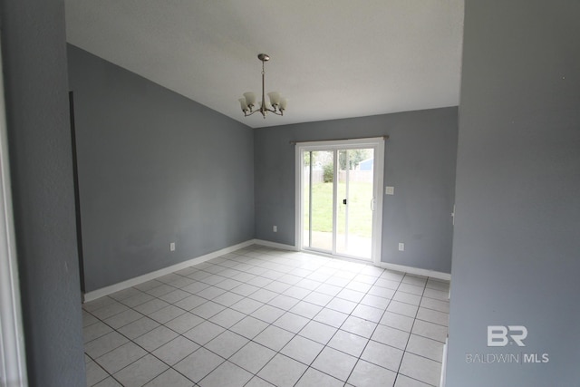 tiled empty room featuring an inviting chandelier